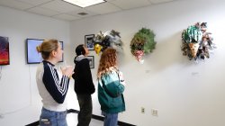 Image of people looking at artwork during a Finley Gallery exhibition