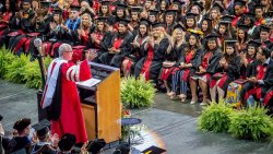 Undergraduate Commencement speaker addresses crowd from podium