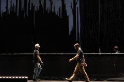 CART Performance Operations. Image of people walking across a dark stage doing technical work.