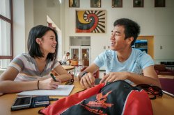 Header image of two students working together