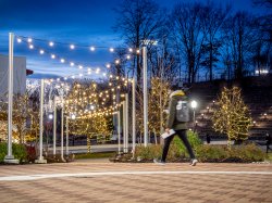 Header image of the campus at night with lights