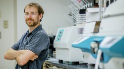 Dr. Matthew Aardema by lab equipment