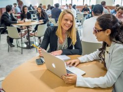 Students speaking at a table