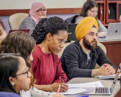 students writing in notebooks in classroom
