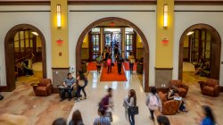 students walking in Feliciano School of Business building