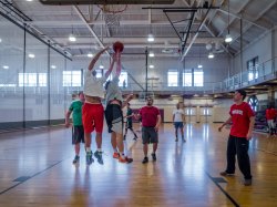 Group of students playing basketball in the gym