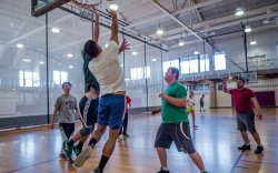 Group of students playing basketball indoors