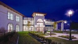 A picture of the student recreation center at night with the lights on