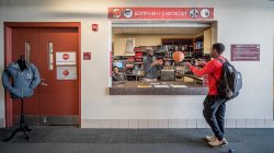 View of Equipment Checkout window with a student checking out a basketball