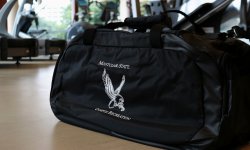 black montlcair state campus recreation duffle bag with the red hawk logo in white