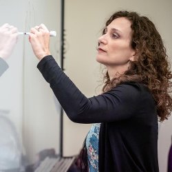 instructor writing on whiteboard
