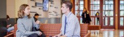 faculty member and student conversing in School of Business lounge