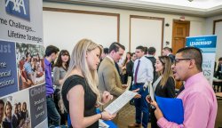 Employers and students talking at a Career Fair.