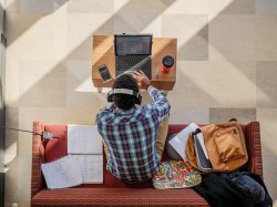 A student sitting in CELS studying on their laptop.