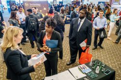 Students networking with employers at the career fair.