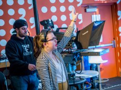 Student directing broadcast during Lester Holt presentation.