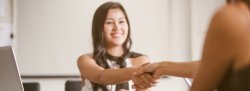 Student shaking hands with employer