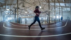 A woman runs on a course.