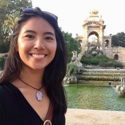 Woman in front of elaborate decorative fountain