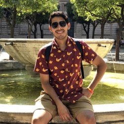 Man sitting on the edge of a fountain