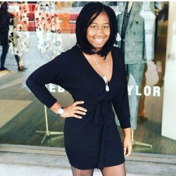 Woman posing in front of boutique