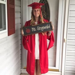 Graduate holding sign reading Ms. Singewald