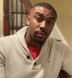 Man leaning on railing on staircase