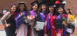 Graduates wearing caps and gowns with bonner ribons