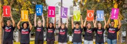 students holding thank you sign