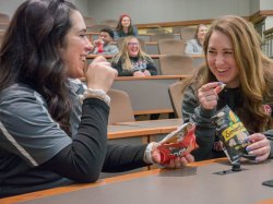 A few students eating snacks and laughing