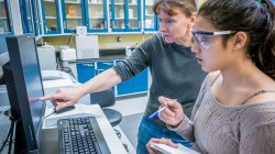 professor and student analyzing data