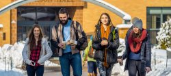 Students walking in winter in front of Dickson Hall