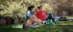 Students sitting on campus in spring