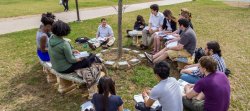 Profressor conducting class outside in spring