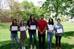 Photo of students standing outside holding certificates