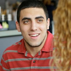 Young man with brown hair smiling