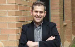Professor David Galef in front of brick wall