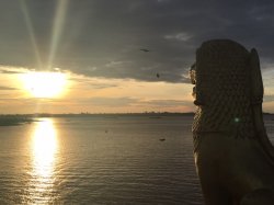 photo of statue in Cambodia overlooking water