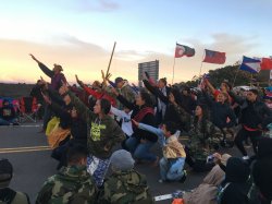 photo of people holding a ceremonial protest in the road