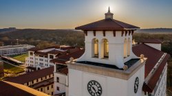 aerial photo of university hall bell tower at golden hour