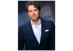 photo of Mark Rotella in a suit with grey backdrop