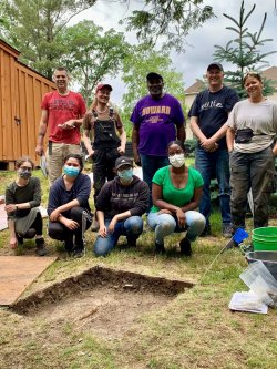 MSU students and field school staff posing in front of an active excavation pit.