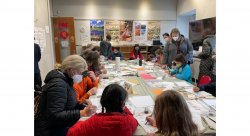 photo of community members at a calligraphy workshop at a Lunar New Year celebration
