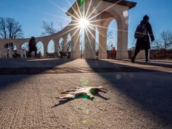 Sun shining through archway on campus