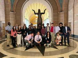 students stand in group photo in front of statue in a rotunda at NJ Federal Court House