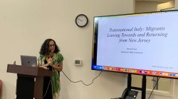 Professor Teresa Fiore at podium and screen for a talk at the YMCA of Montclair