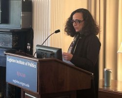 Teresa Fiore speaking at a podium at Rutgers University