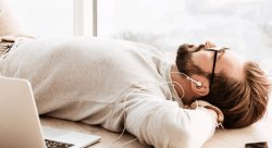 Photo of man listening to a podcast with headphones