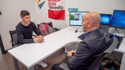 Advisor sitting with a student