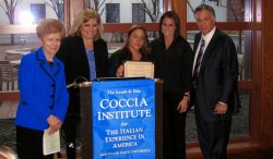 Presenters and awardee posing behind podium